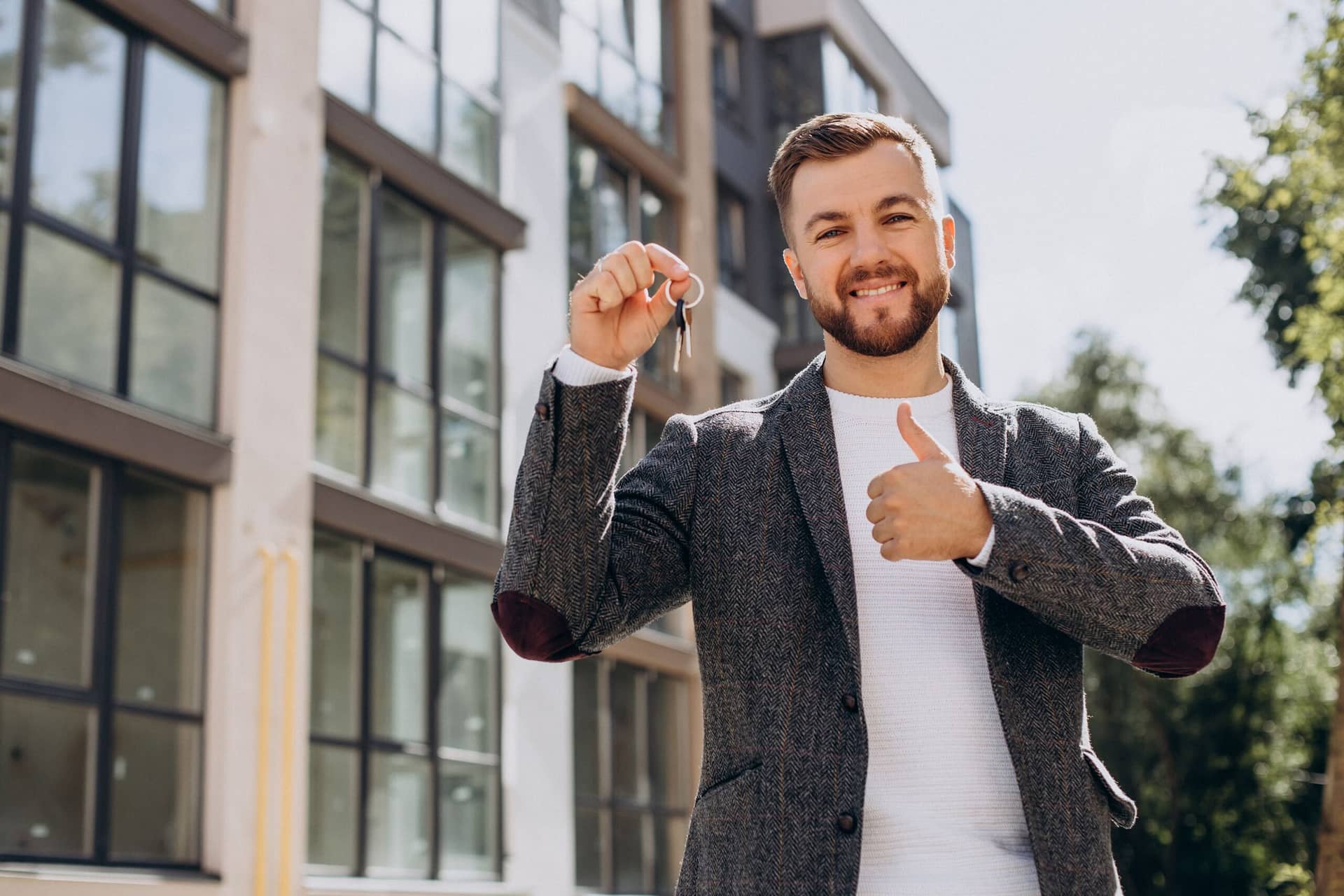 young-man-with-keys-just-bought-new-appartment